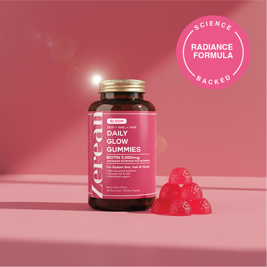 Zerean Bloom Daily Glow Gummies bottle on pink background — science-backed beauty formula with biotin, vitamin C, and vitamin E for radiant skin and hair.